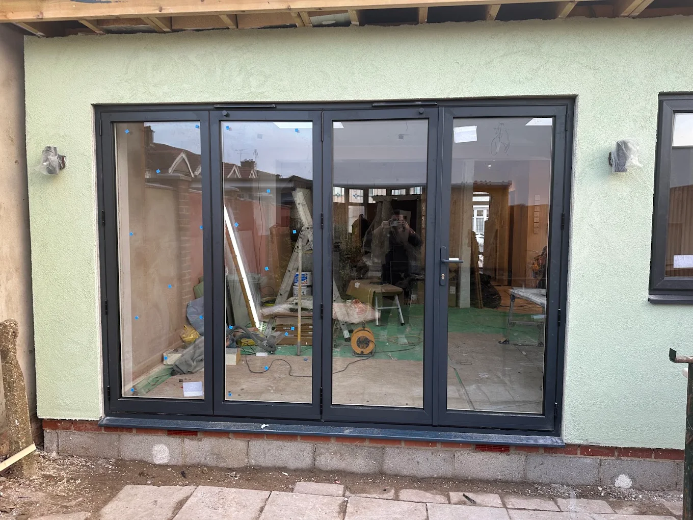 grey aluminium bifold doors opening to garden, fitted in Hornchurch